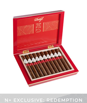 Open red humidor displaying cigars with 'Year of the Pig' design on a white background
