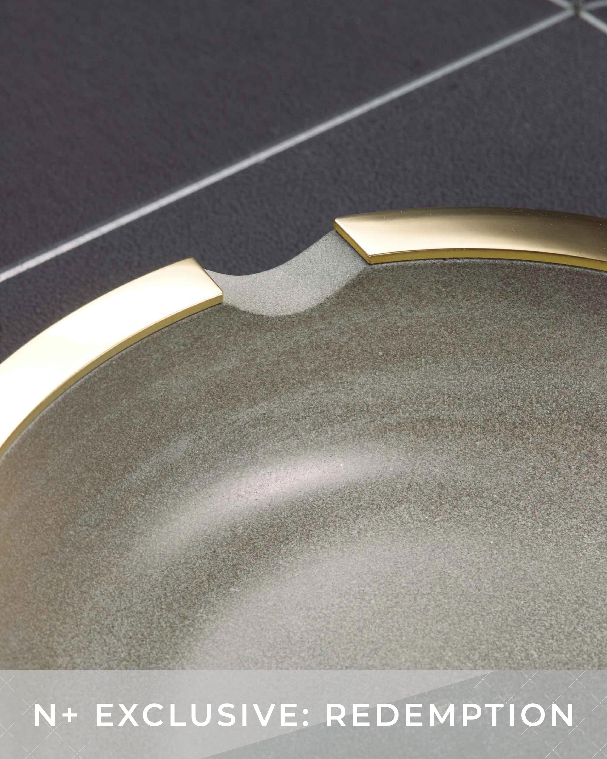 Close-up of a metallic object with a gold rim on a dark background
