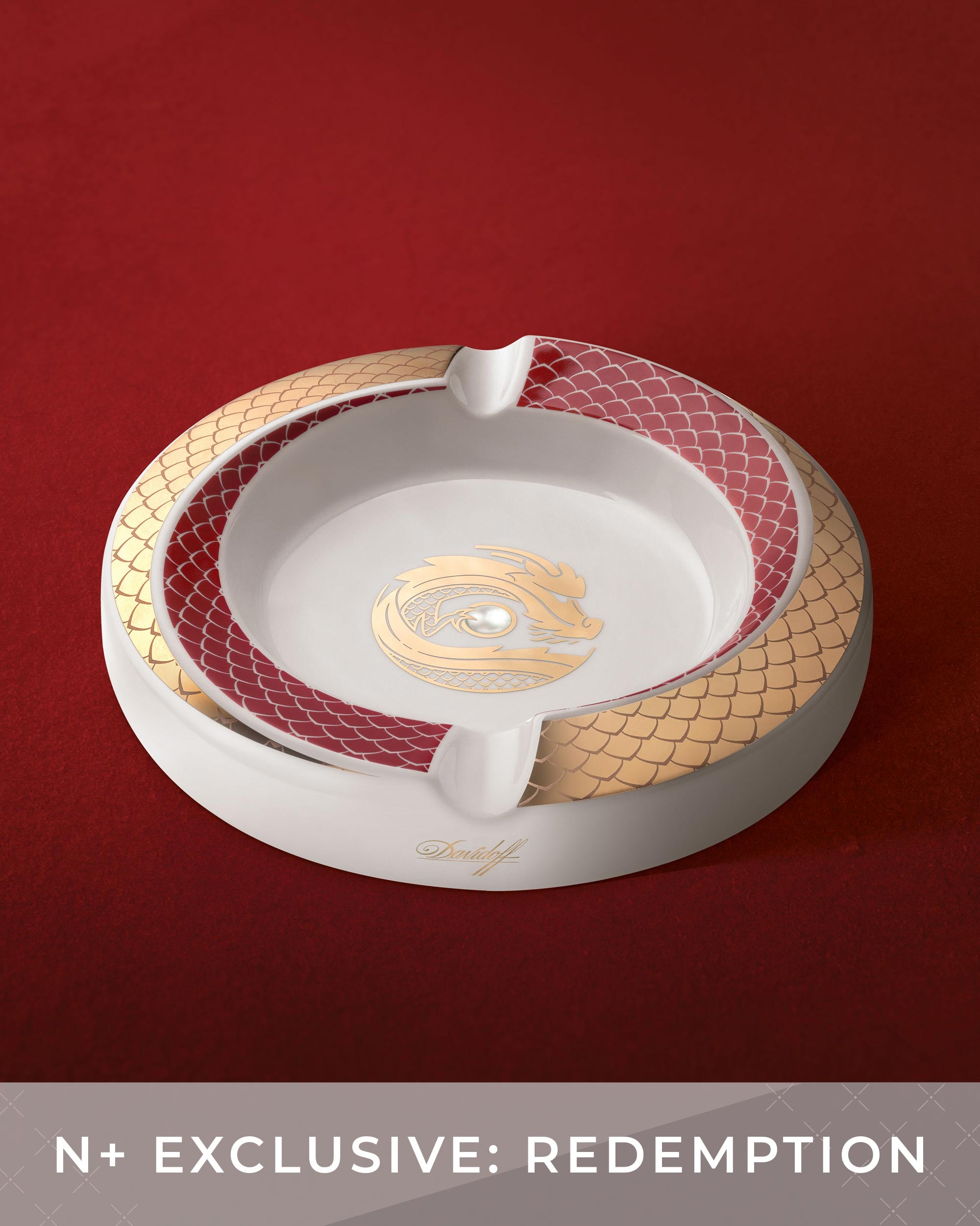Decorative ashtray with gold and red accents on a red background