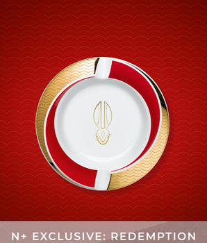Decorative plate with gold and red design on a red background