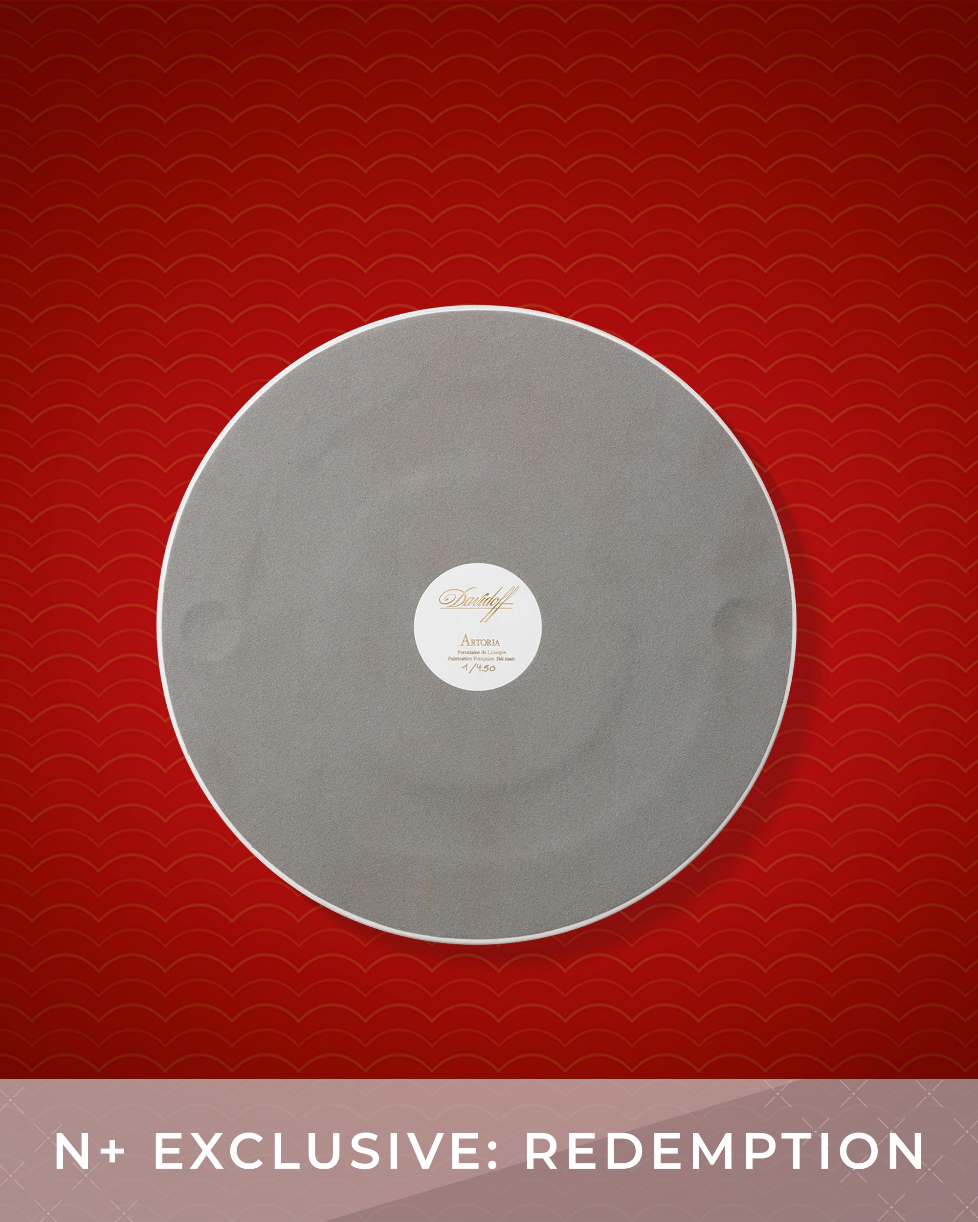 Gray vinyl record with a label on a red background, featuring the text 'N+ Exclusive: Redemption'.