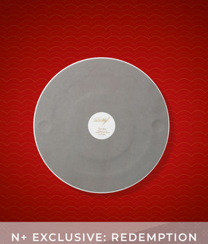 Gray vinyl record with a label on a red background, featuring the text 'N+ Exclusive: Redemption'.