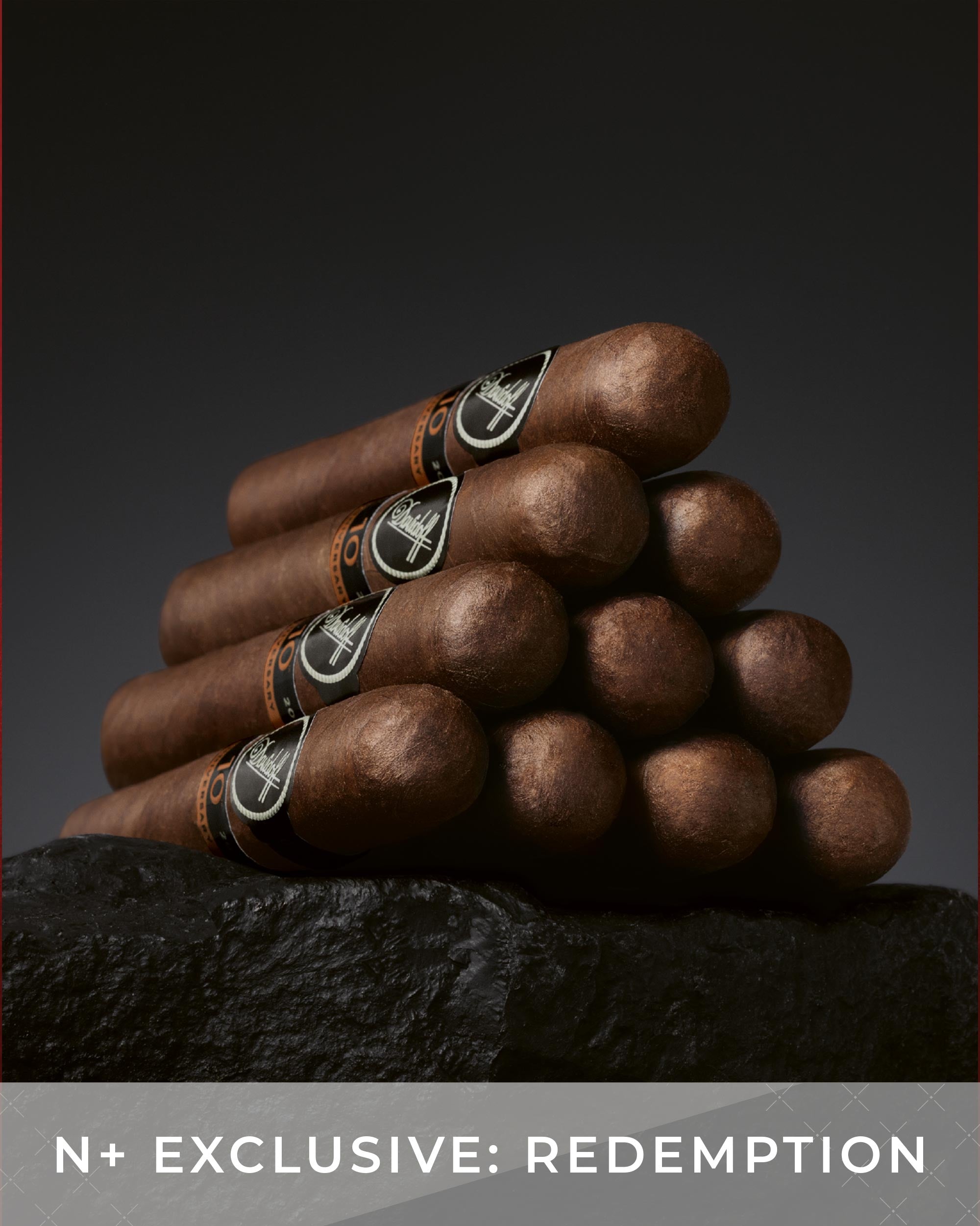 Stack of cigars with 'Redemption' branding on a dark background