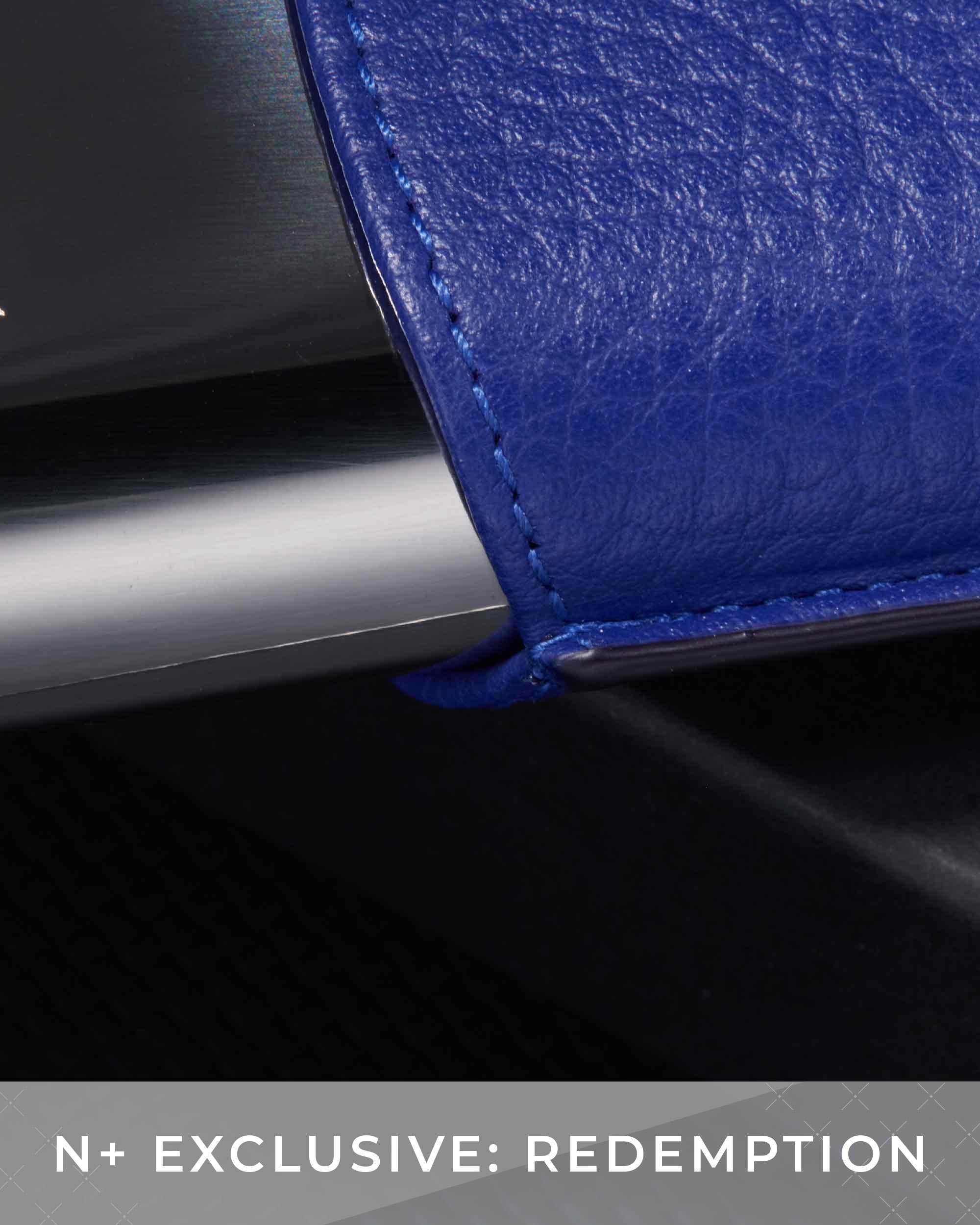 Close-up of a blue leather product with metallic trim on a dark background, featuring text 'N+ Exclusive: Redemption'.