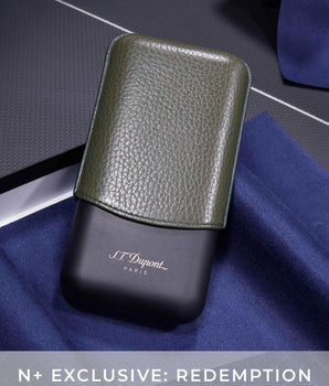 Green leather case on a black base with 'J.L. Dupont' branding, placed on a blue fabric background.