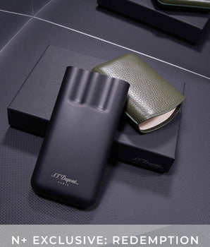 Black and green S.T. Dupont products on a dark textured surface with 'N+ Exclusive: Redemption' text.