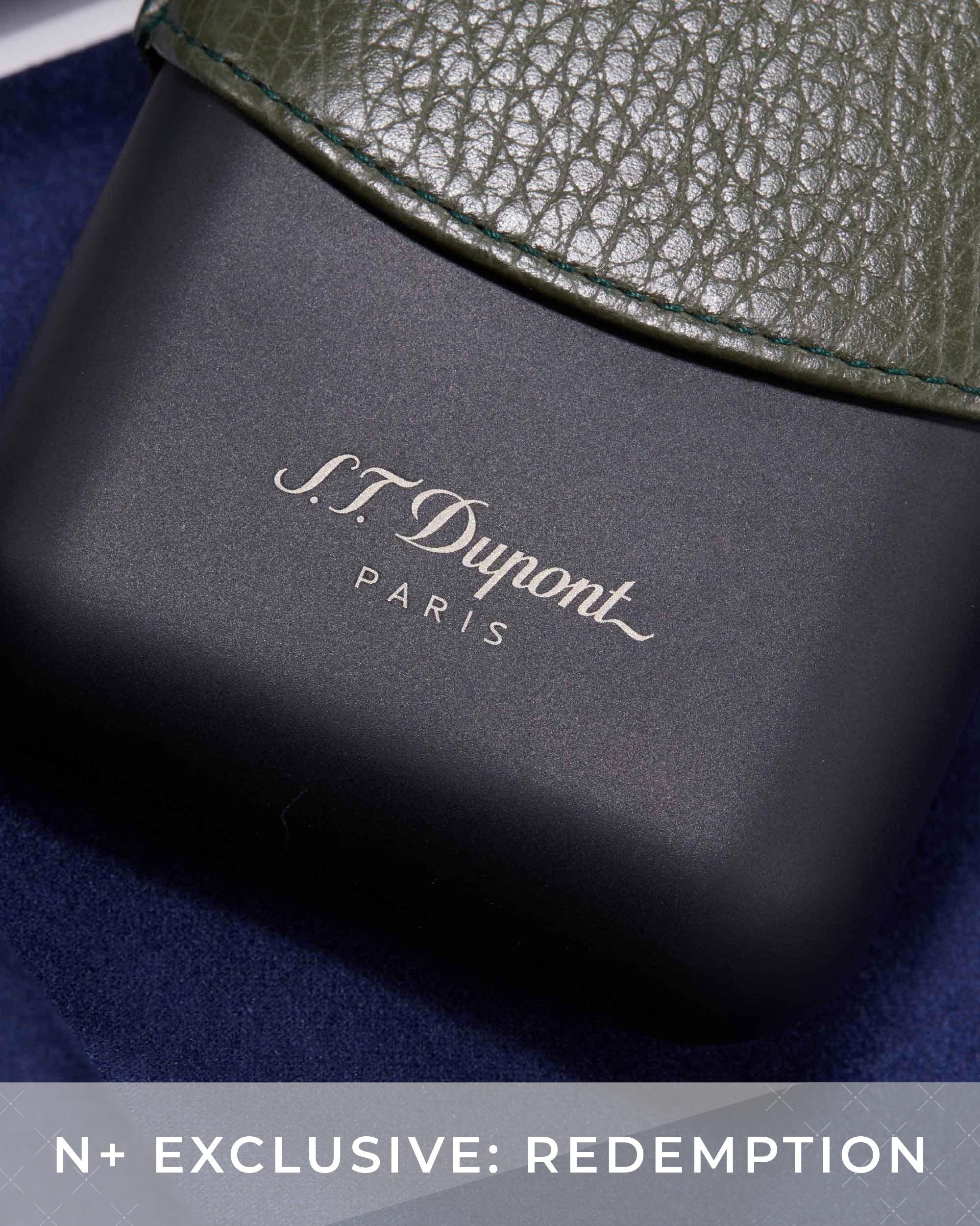 S.T. Dupont case with green leather top on a blue background