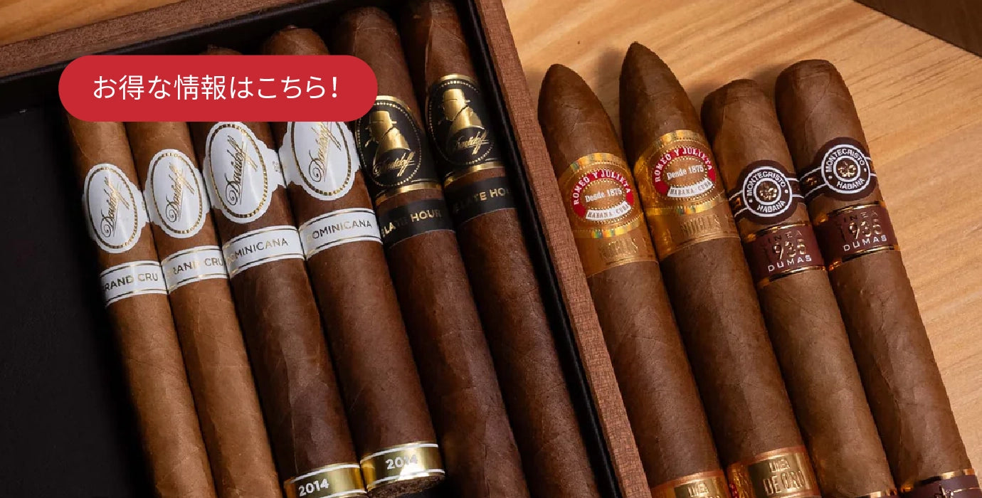 Assorted cigars with visible labels in a wooden humidor.
