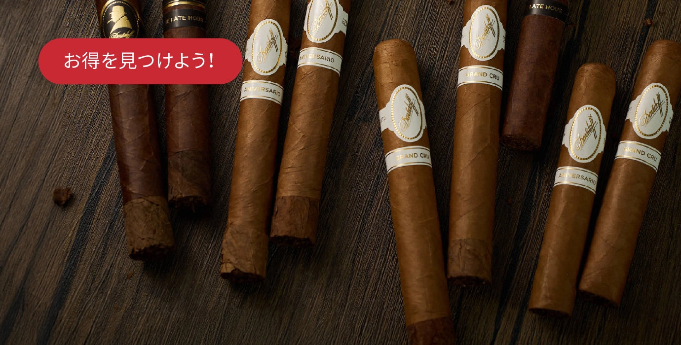 Cigars with labels on a wooden surface, featuring Japanese text.
