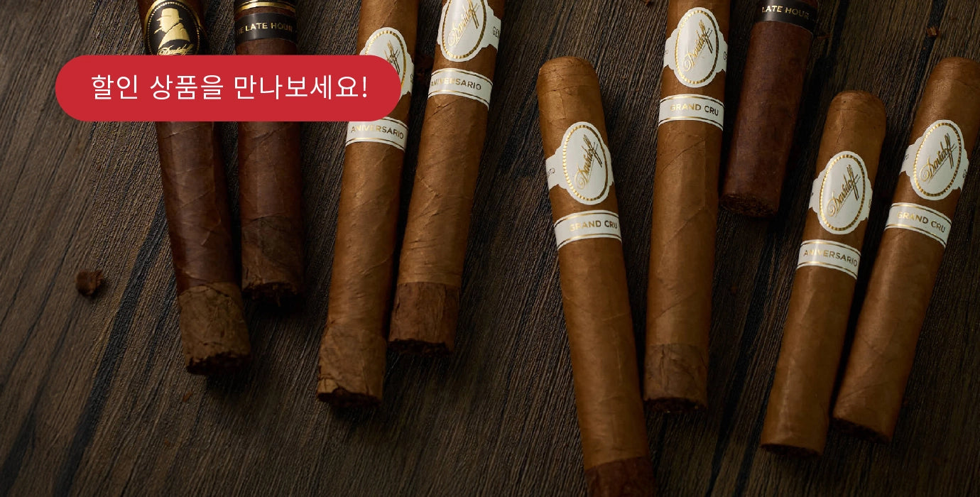 Assorted cigars with visible branding on a wooden surface