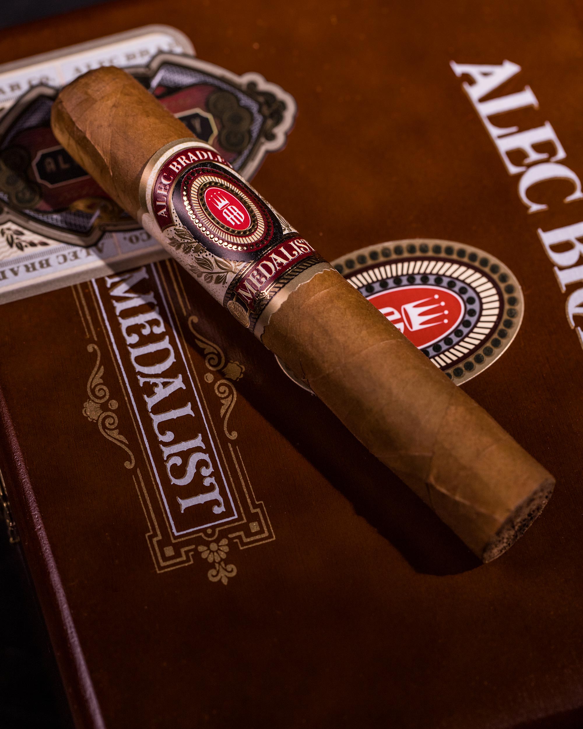 Cigar with Alec Bradley branding on a wooden surface