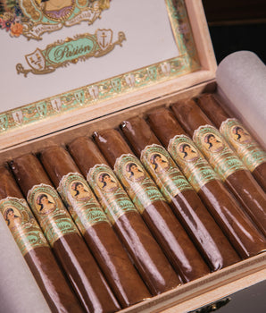 Open humidor with cigars and a visible brand logo on the lid.