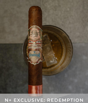 Cigar with a label on a metallic stand against a neutral background