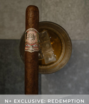 Cigar with a label on a dark background, featuring the text 'N+ Exclusive: Redemption'.