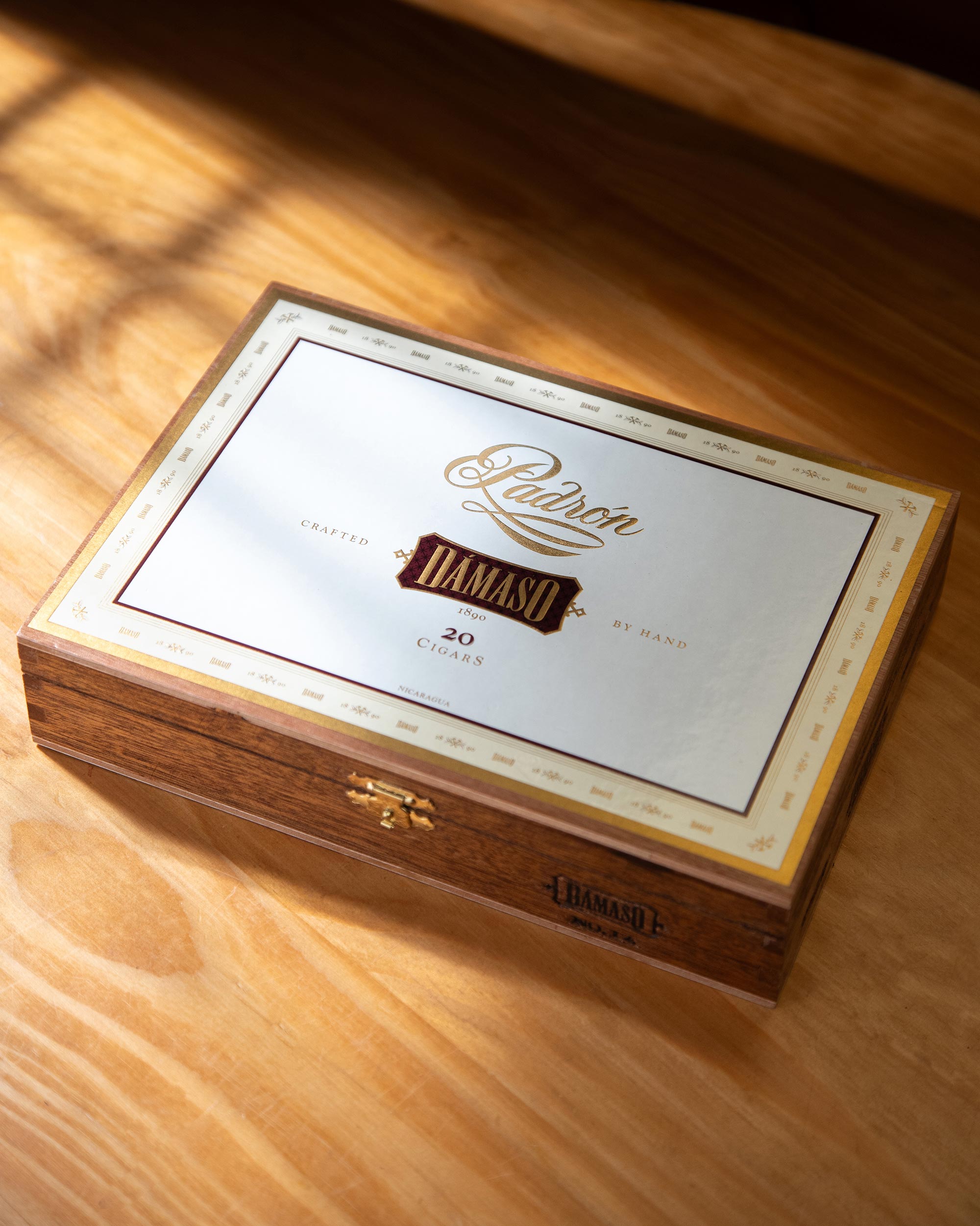 Padron Damaso cigar box on a wooden surface
