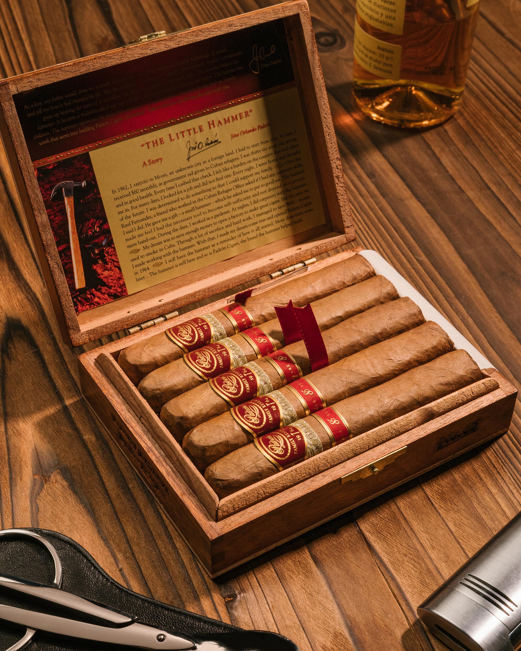 Open wooden humidor with cigars on a wooden surface