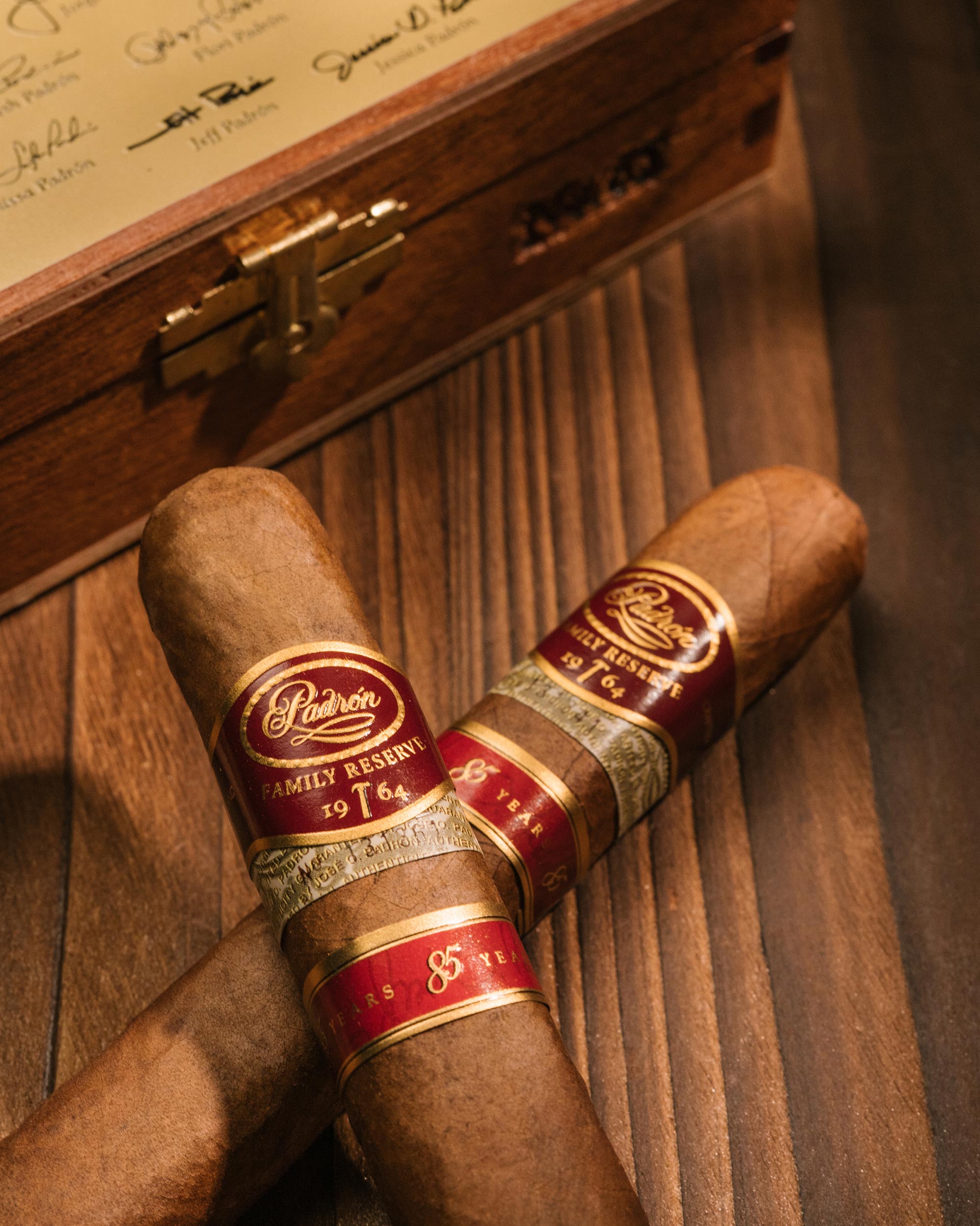 Two cigars with Lindtner Family Reserve branding on a wooden surface.