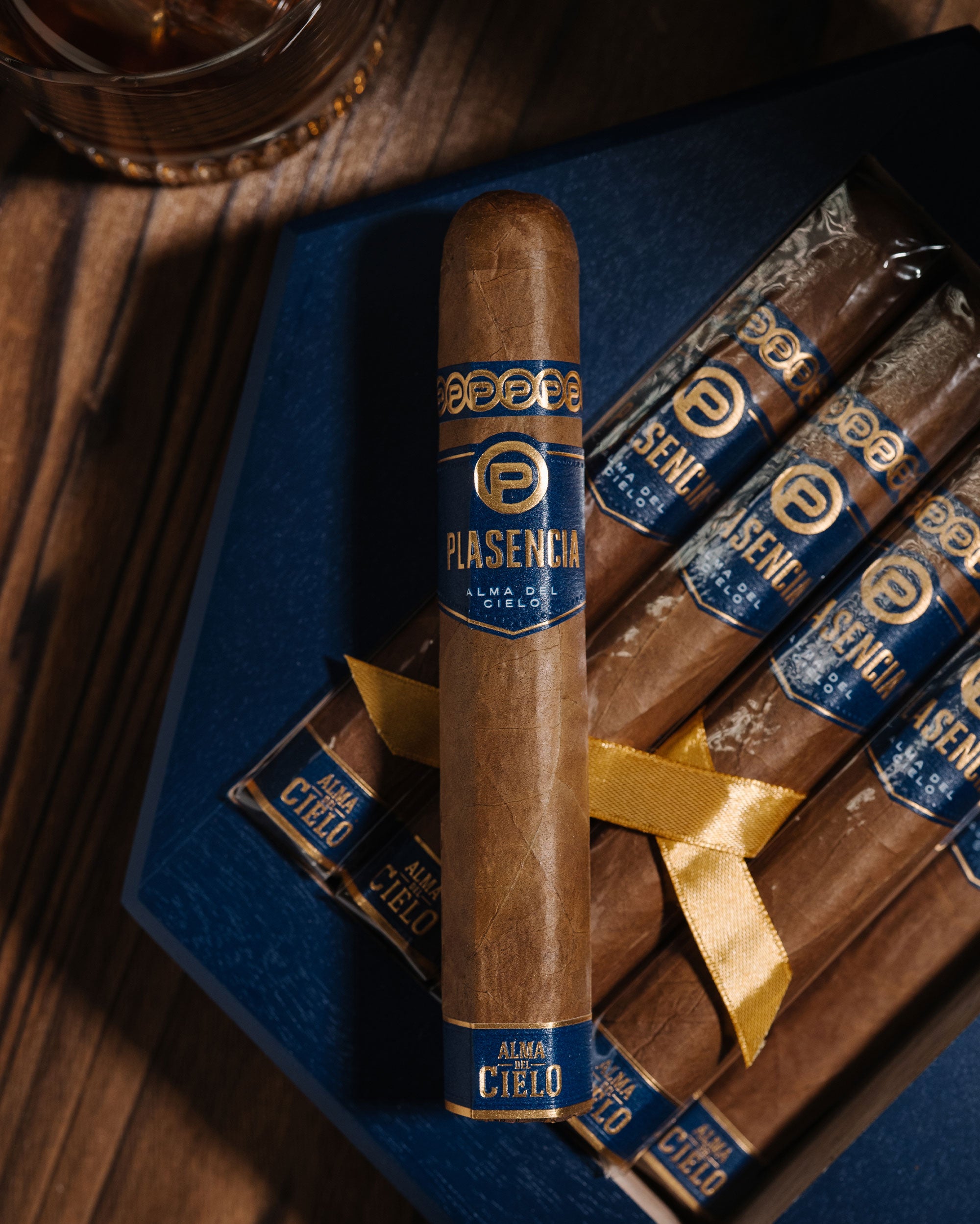 Plasencia cigars with blue labels on a wooden tray