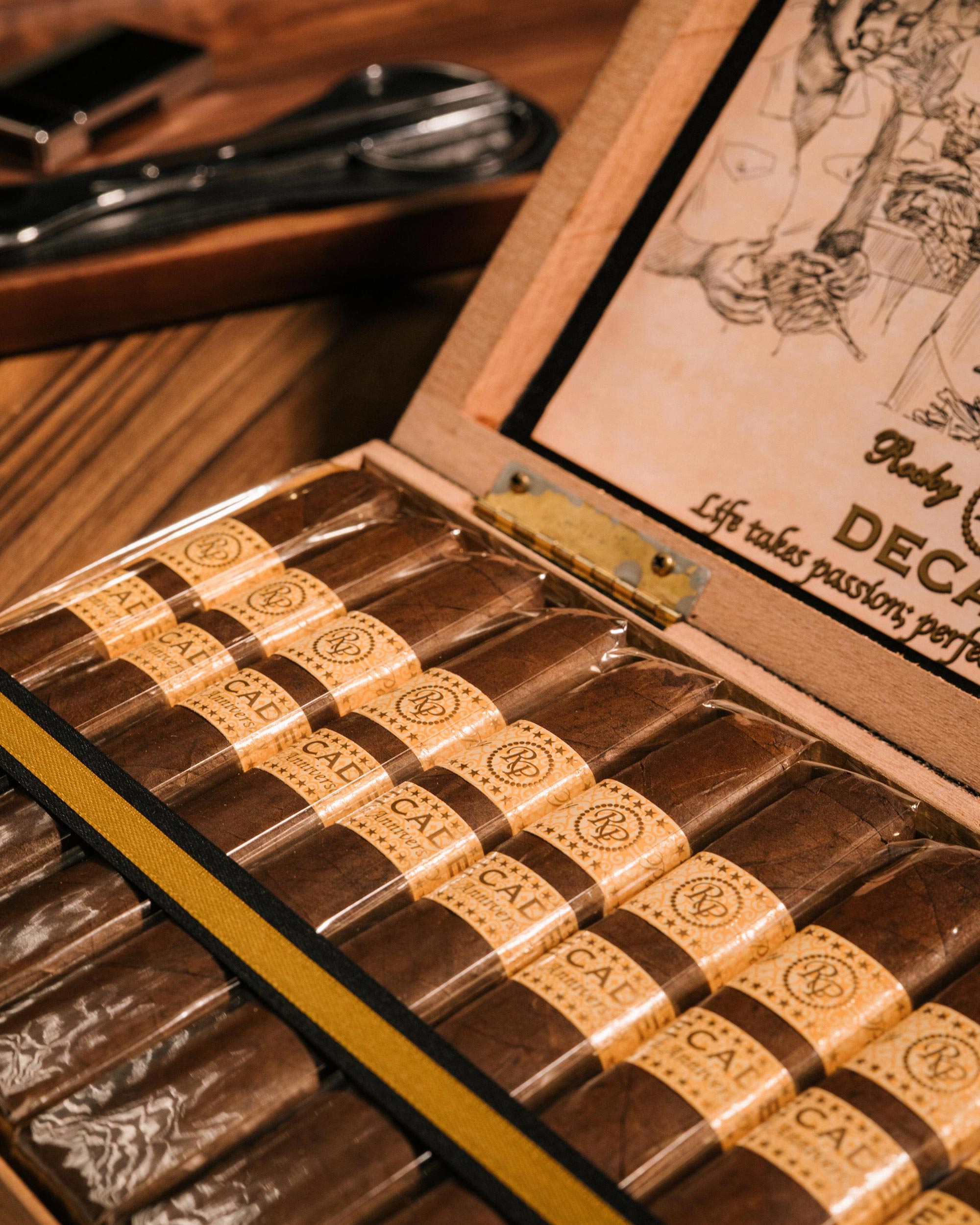 Chocolate bars in a wooden box with a brand logo on a wooden surface.