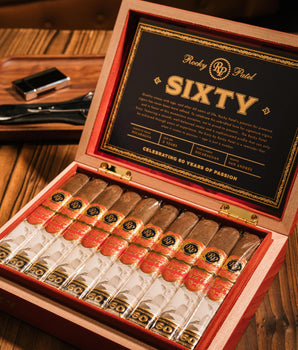 Open humidor with Rocky Patel Sixty cigars on a wooden table