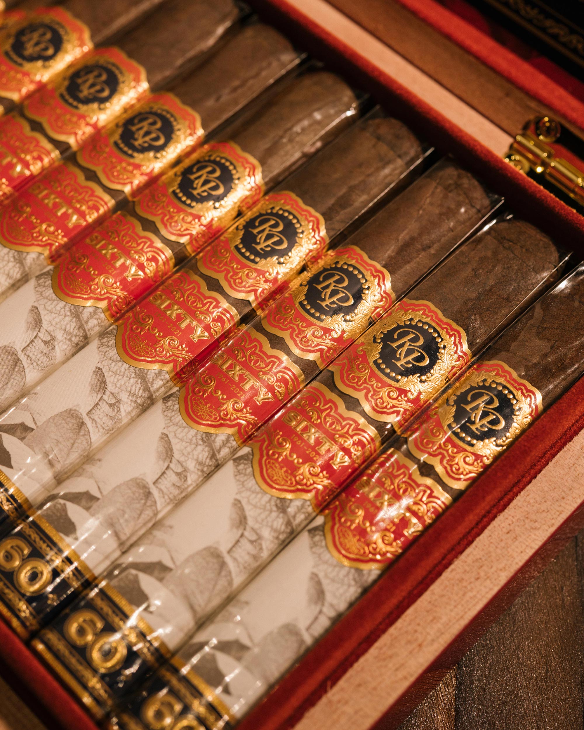 Close-up of a box of premium cigars with decorative labels.