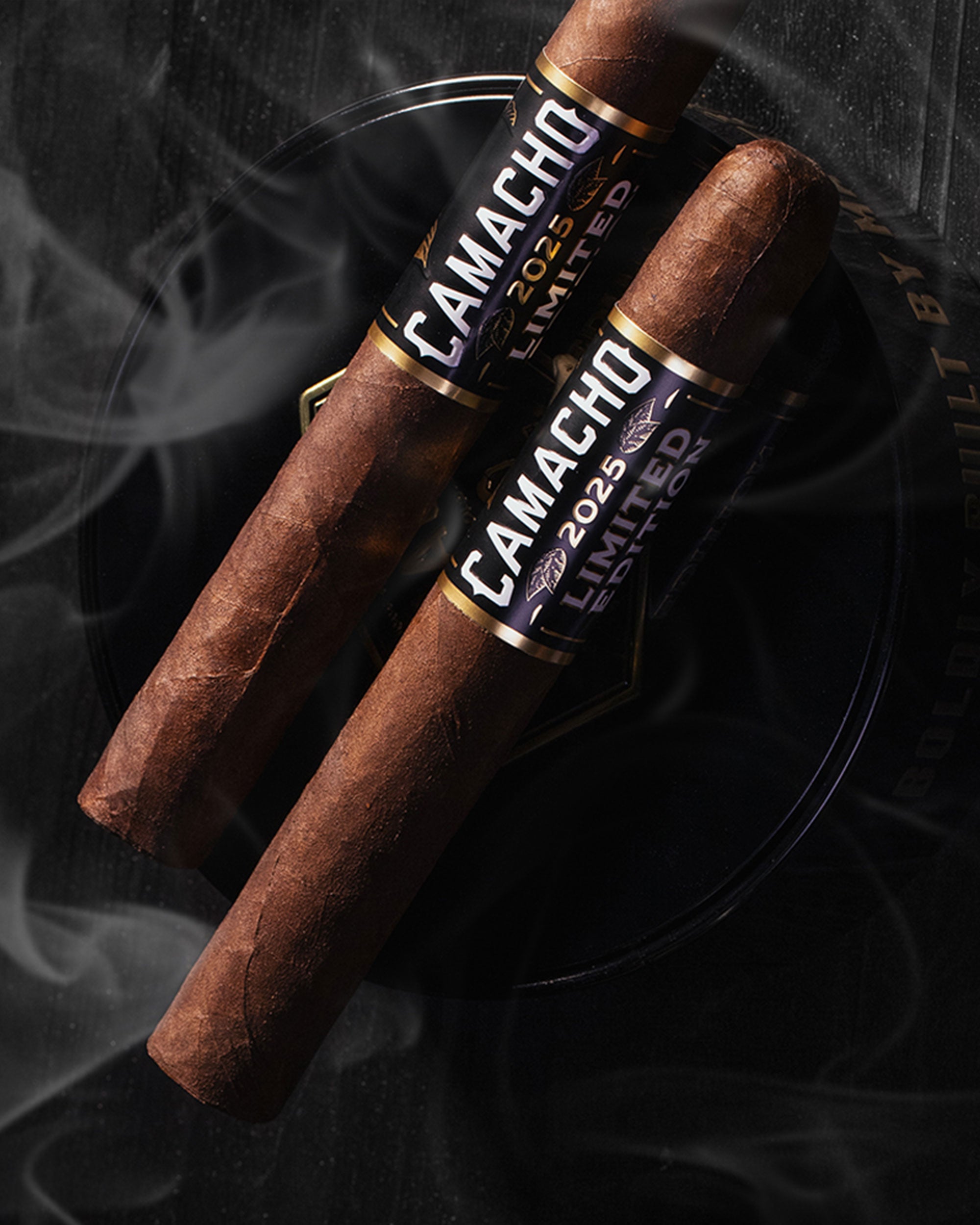 Two Camacho cigars with a dark background