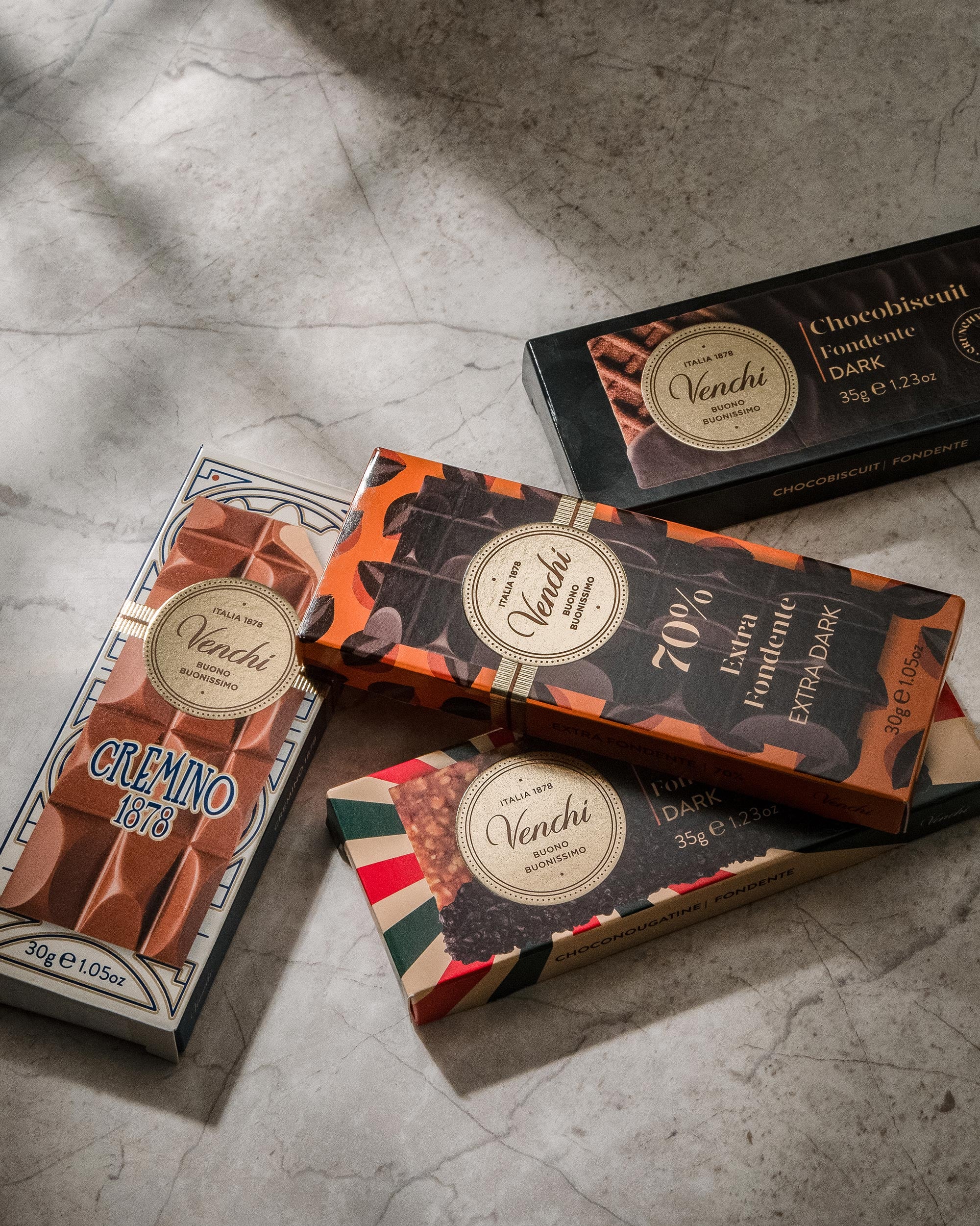 Venchi chocolate bars on a gray surface