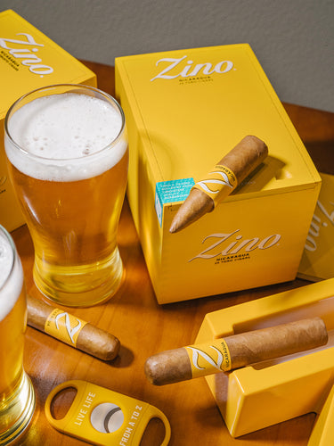Zino cigars with a glass of beer on a wooden table