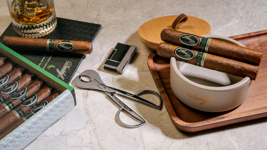Cigars with accessories on a marble surface