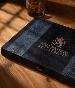 Cigar box with Liga Privada branding on a wooden surface