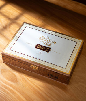 Padron Damaso cigar box on a wooden surface