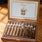 Open wooden box of Padron cigars on a wooden surface