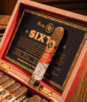 Cigar in a Rocky Patel Sixty box with visible branding