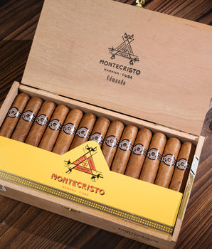 Montecristo cigars in a wooden box on a wooden surface