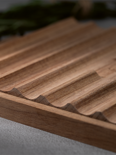 Wooden cutting board with a textured surface on a blurred background